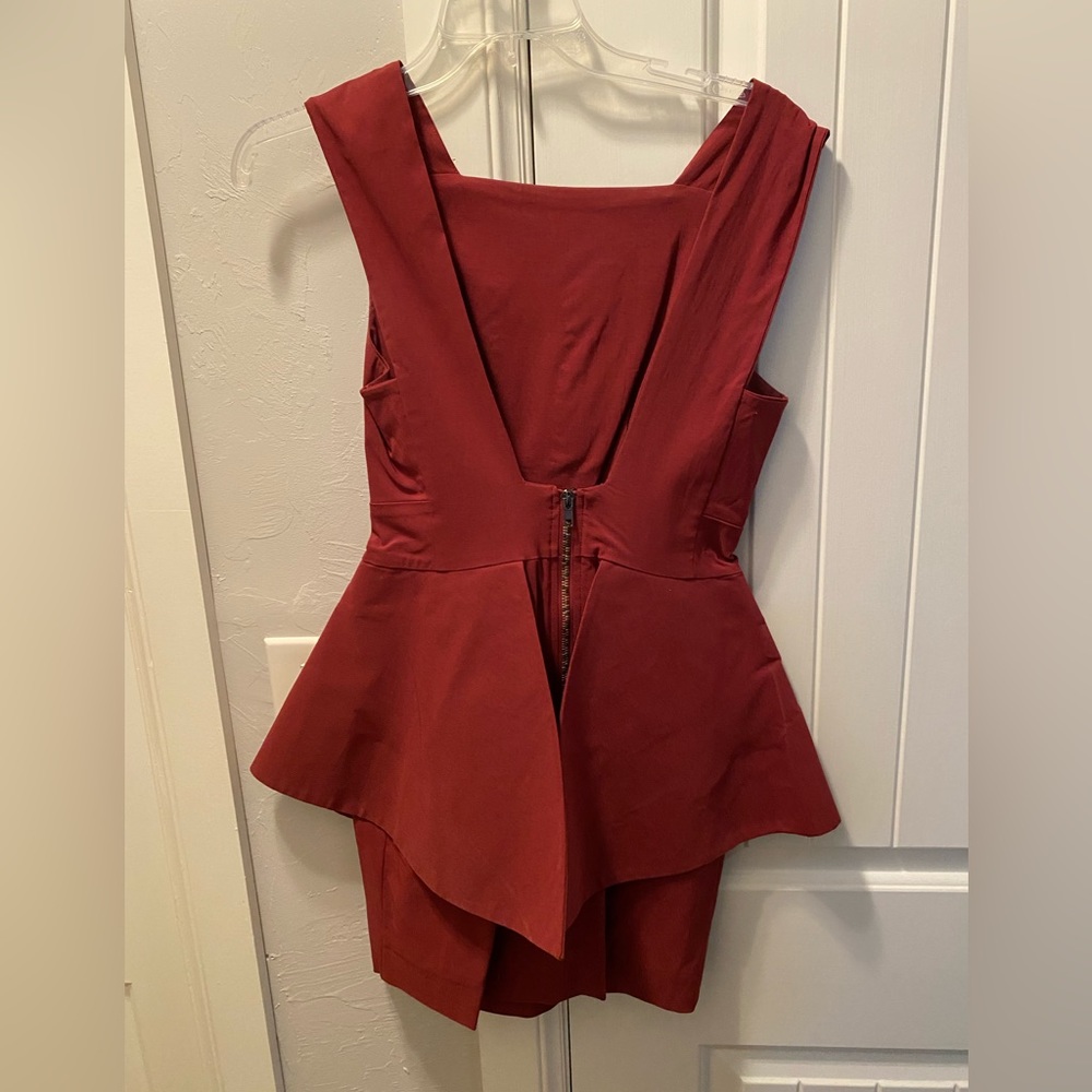 Burgundy low back peplum dress. Small